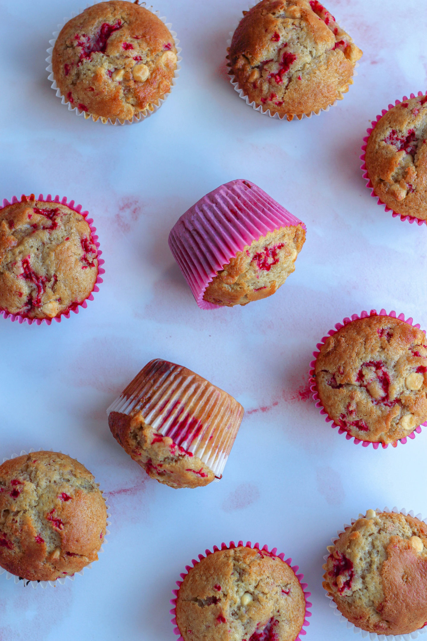 assortment of raspberry white chocolate muffins taken from above