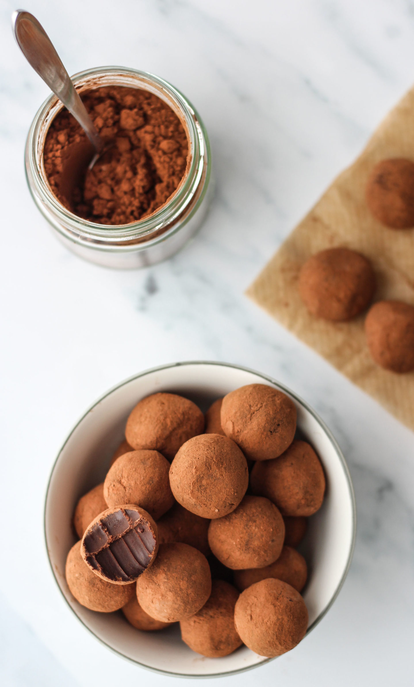 chocolate truffles in bowl and jar of cocoa powder