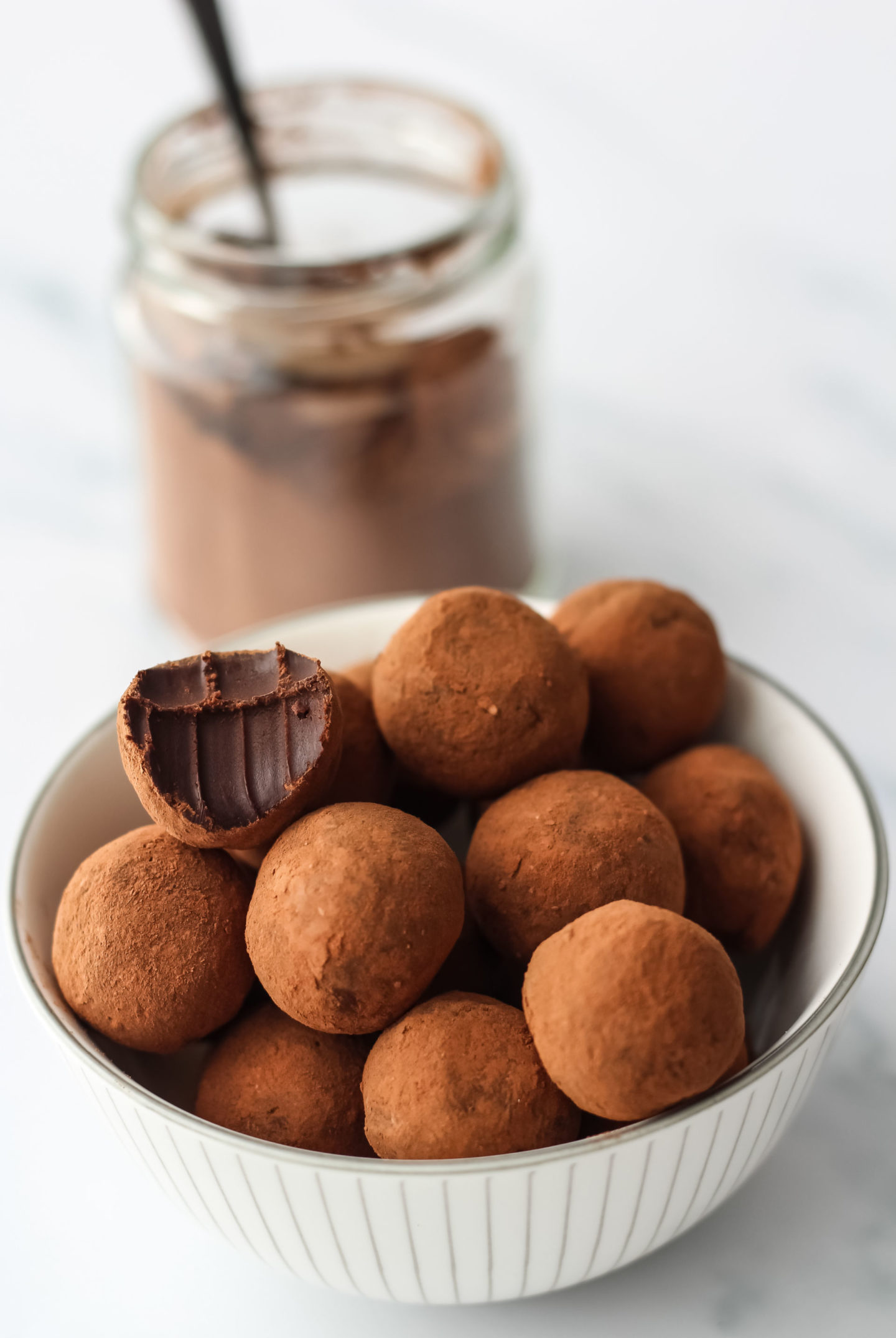 bowl of truffles with jar of cocoa powder