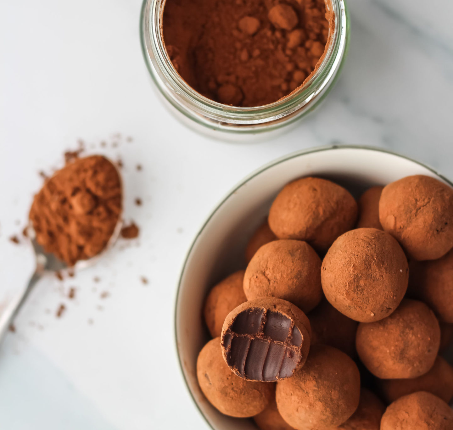 truffles, cocoa powder in jar and spoon of cocoa