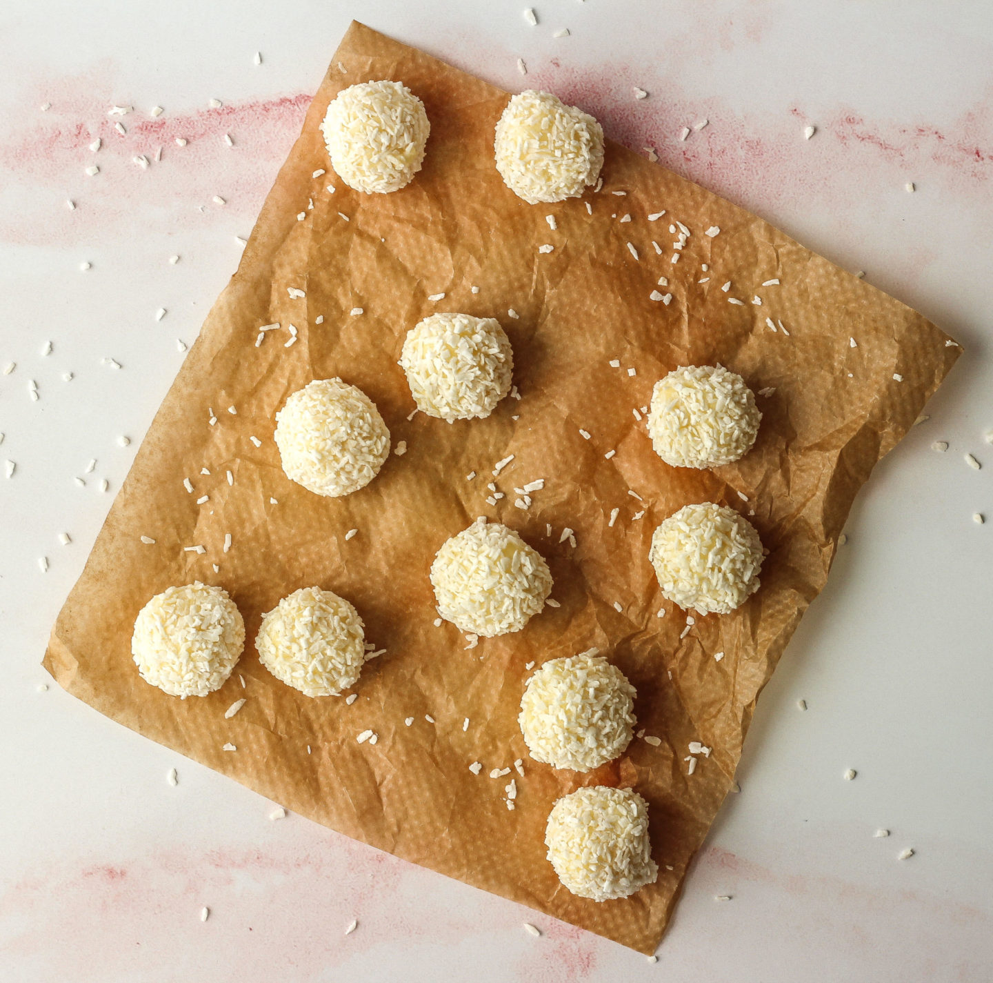 several white chocolate coconut truffles on baking paper