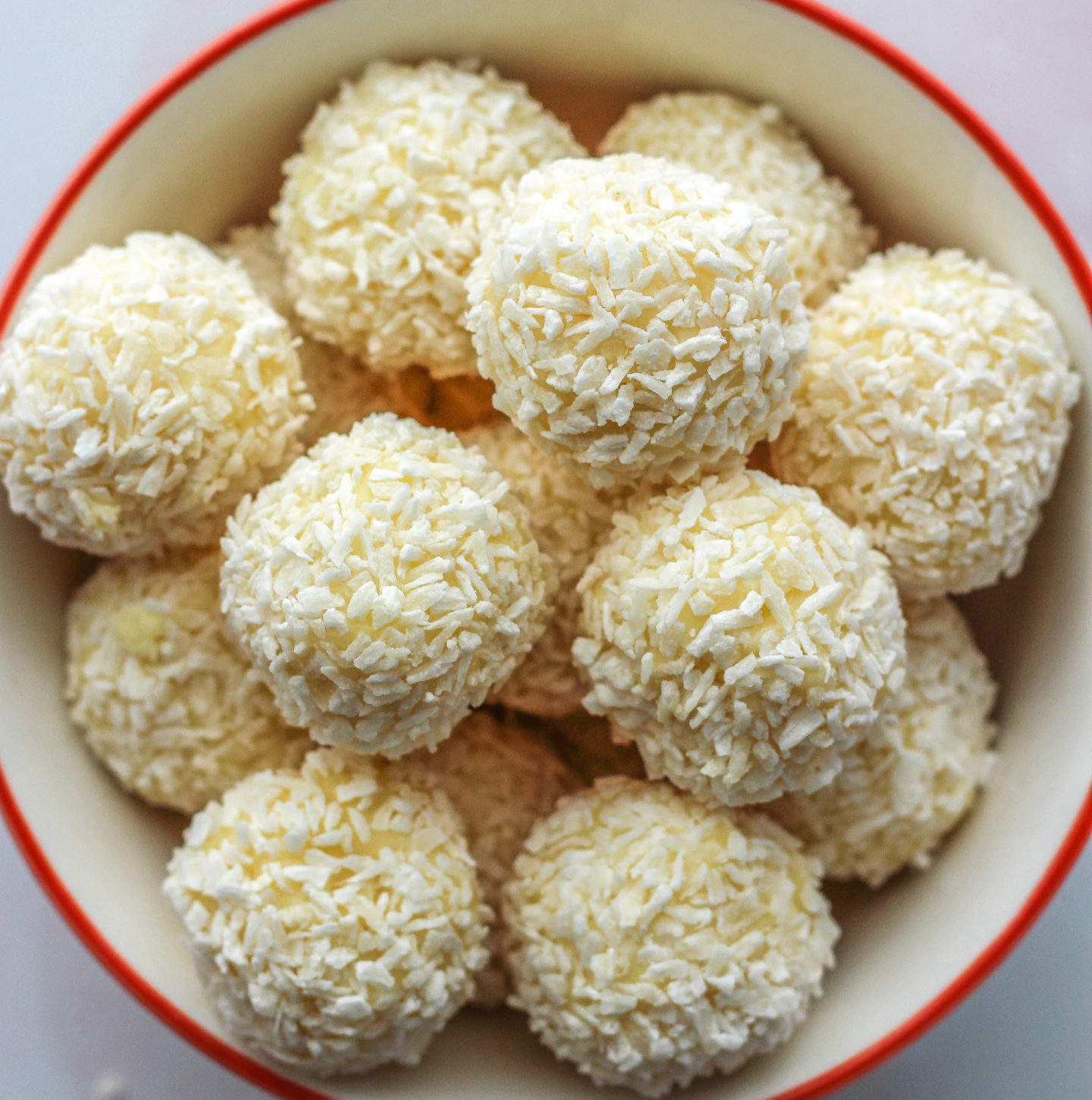 close up of bowl of white chocolate coconut truffles