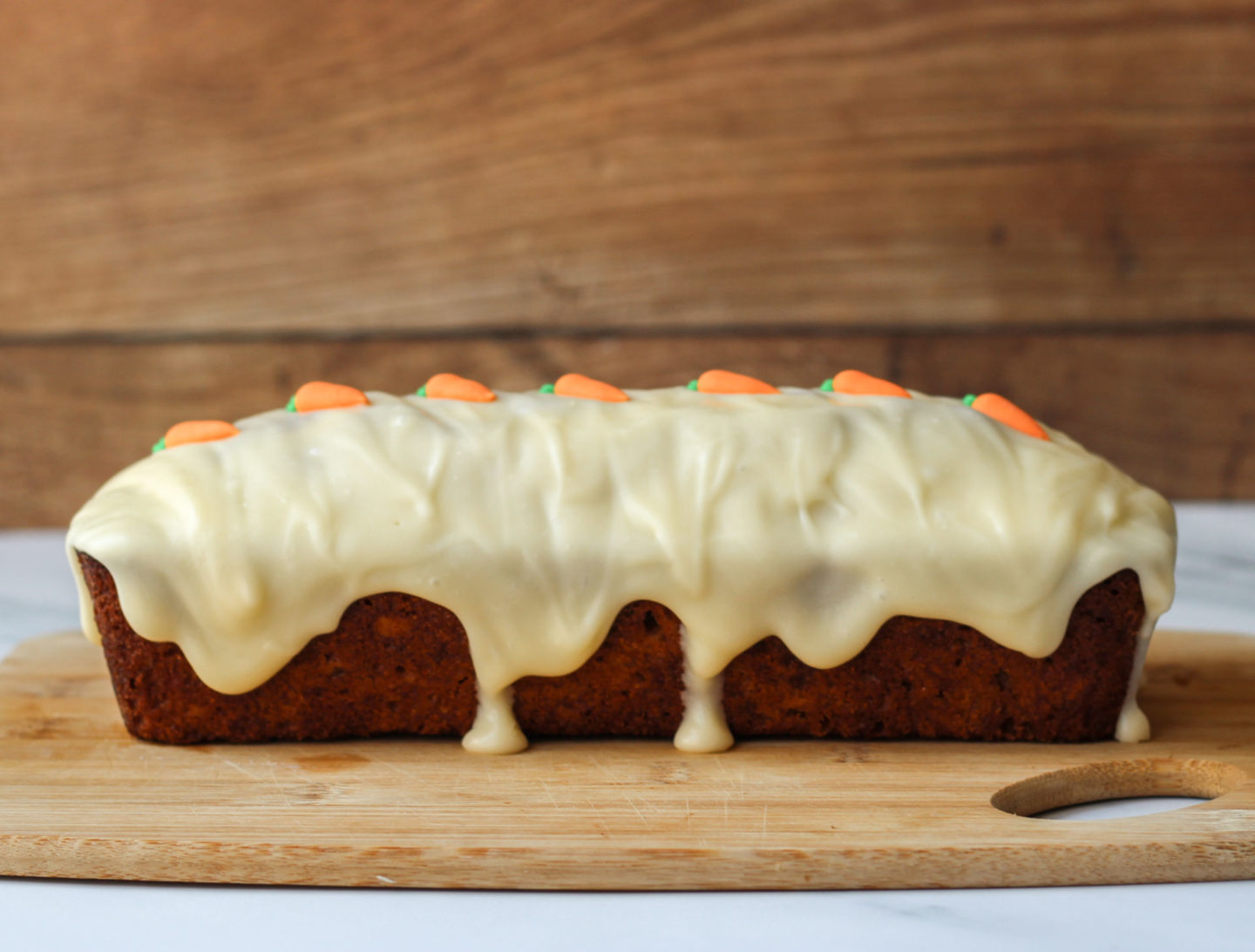 side view of loaf cake with drip icing