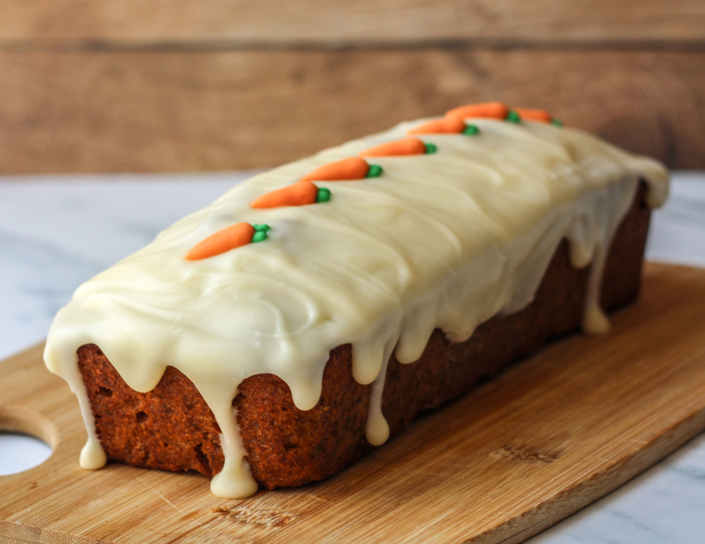 carrot loaf cake covered in cream cheese drip icing