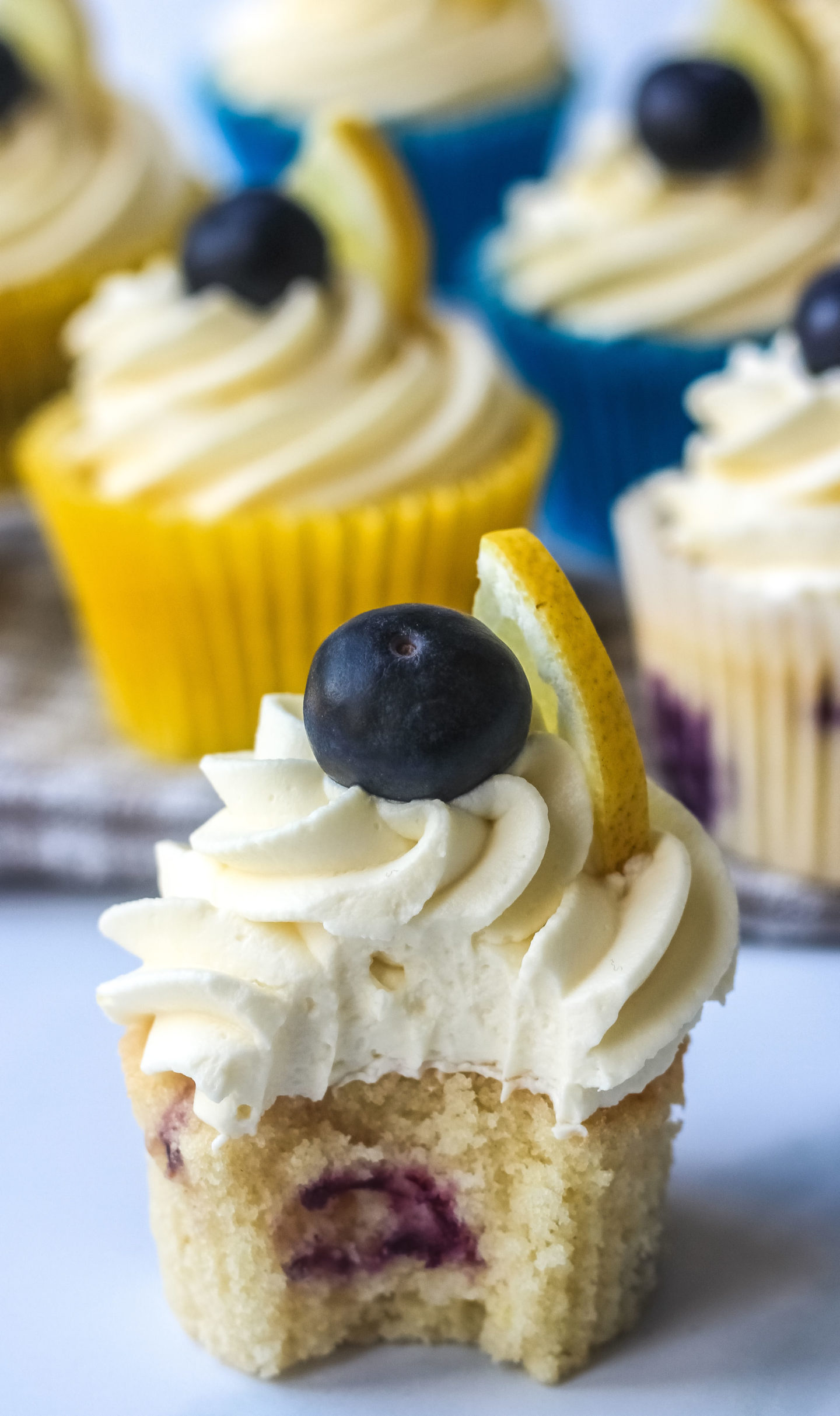 lemon blueberry cupcake with bite taken to show texture inside