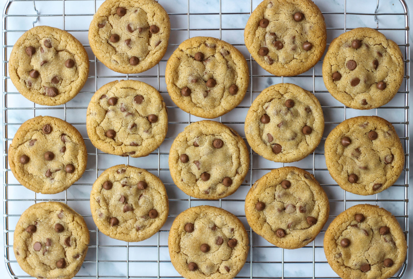 View from above of a wire rack full of chewy chocolate chip cookies