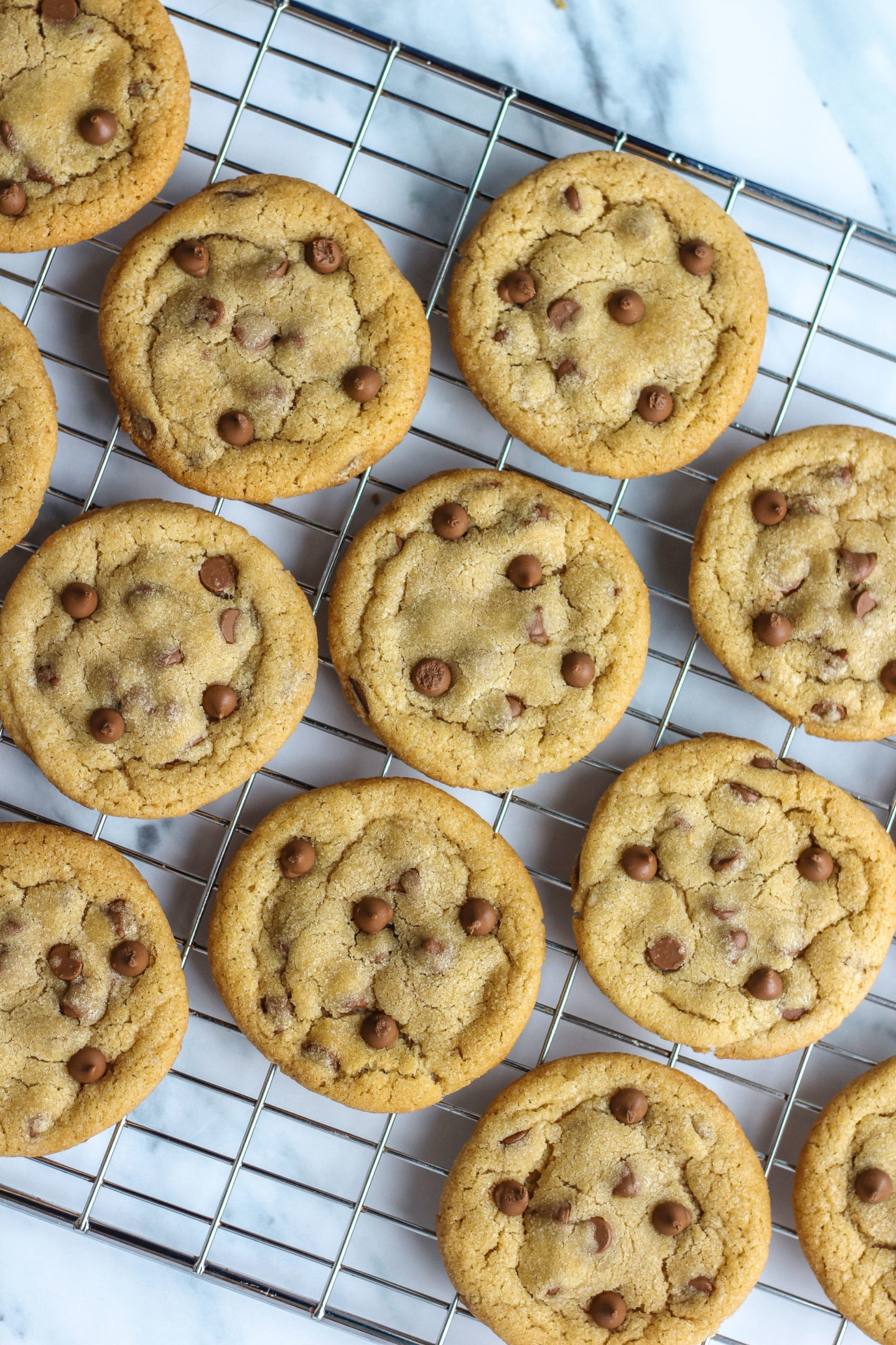 Wire rack full of chewy chocolate chip cookies