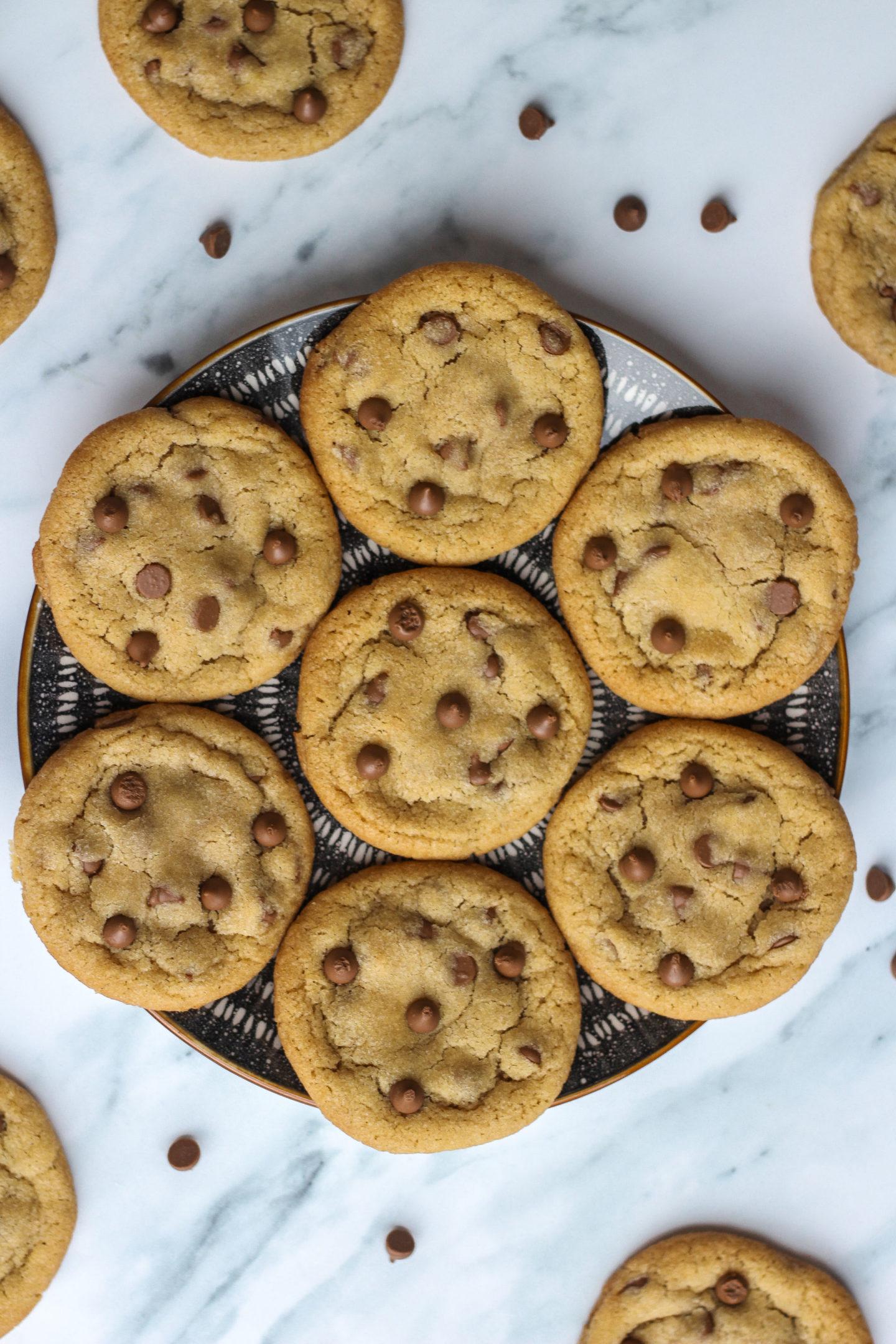 View from above of plate of several chewy chocolate chip cookies