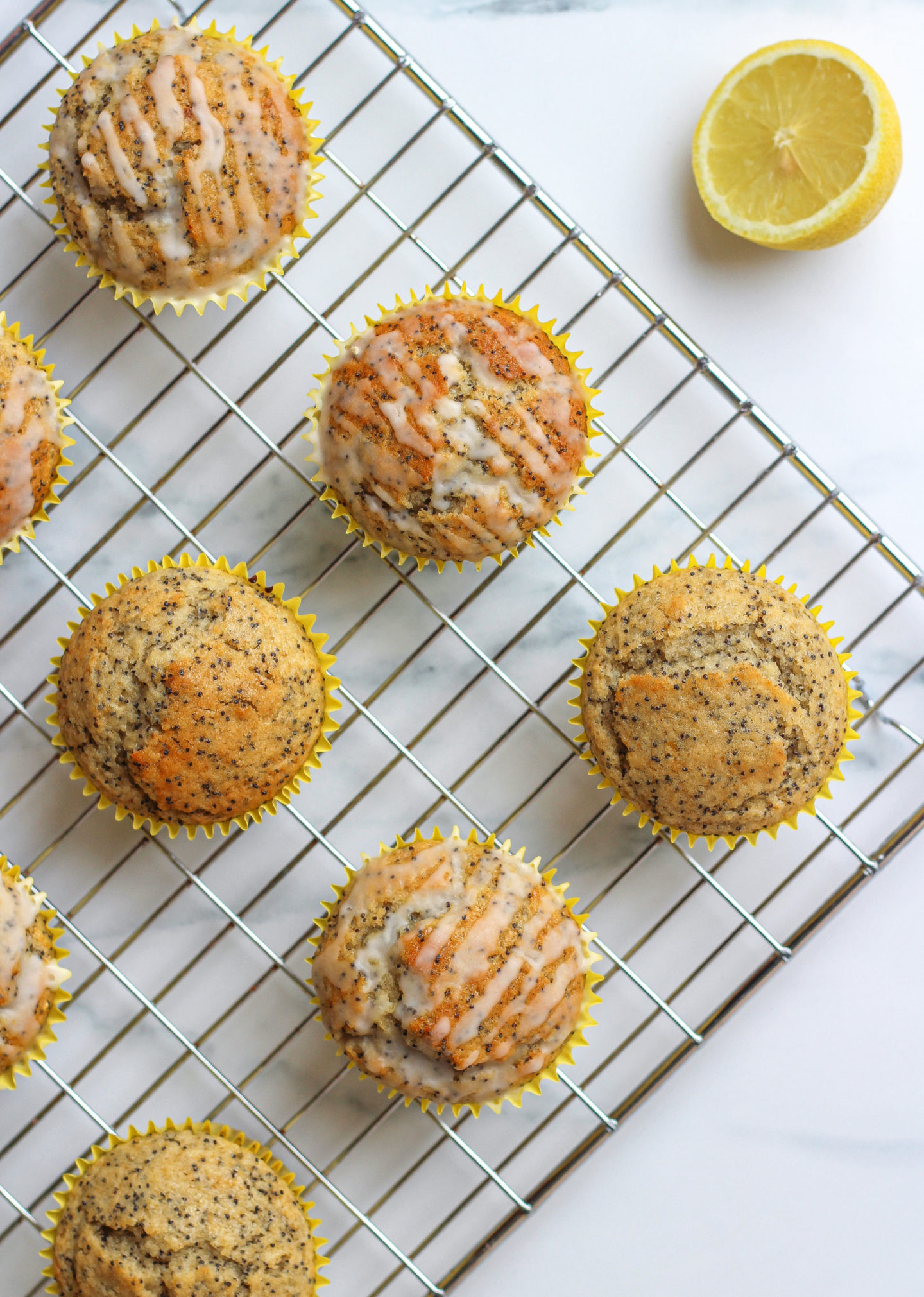 view from above of several lemon poppy seed muffins on wire rack