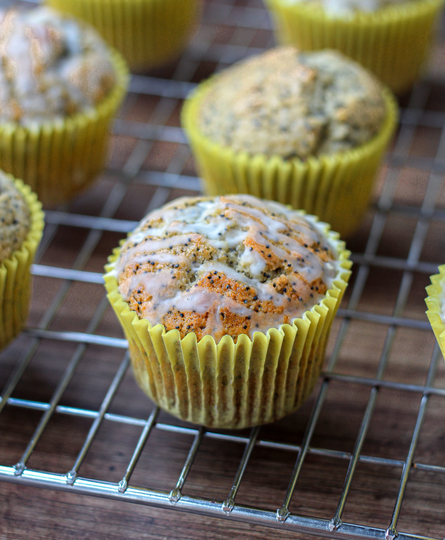 close up of lemon poppy seed muffin drizzled with lemon glaze