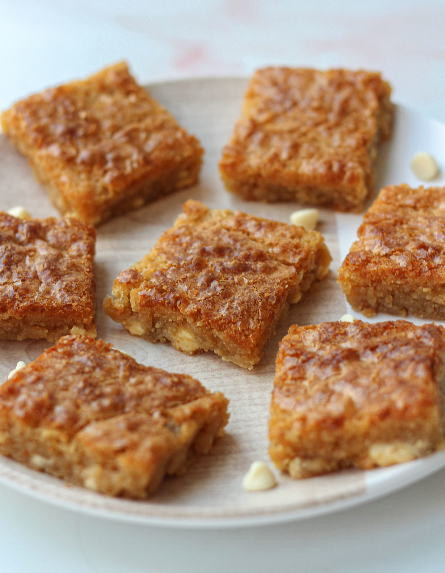 Close up a plate with several white chocolate blondies