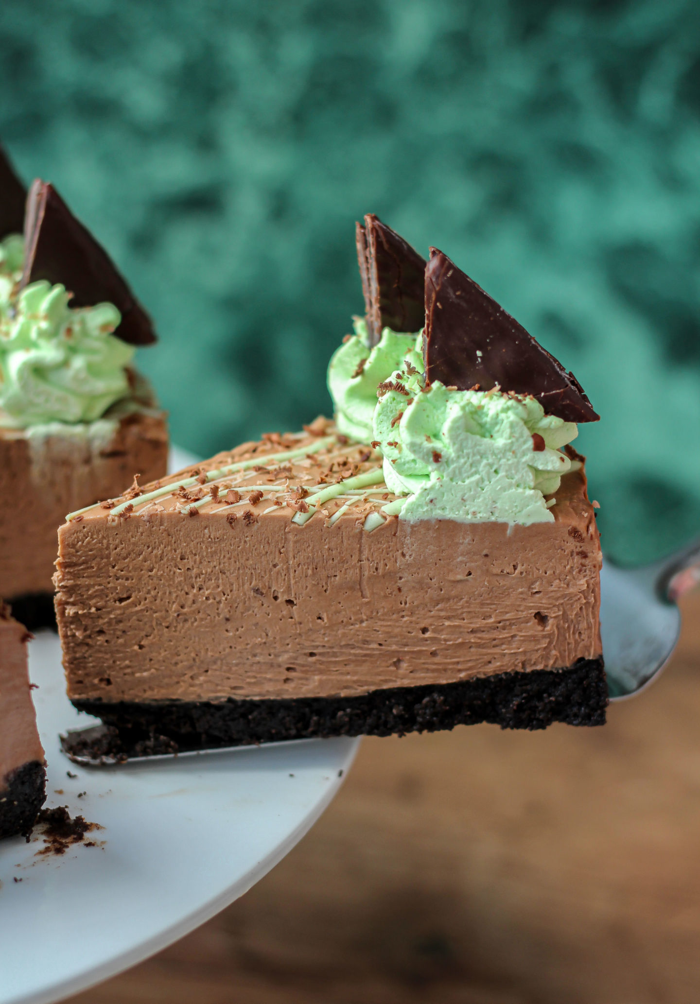 Close up of individual slice of no-bake mint chocolate cheesecake