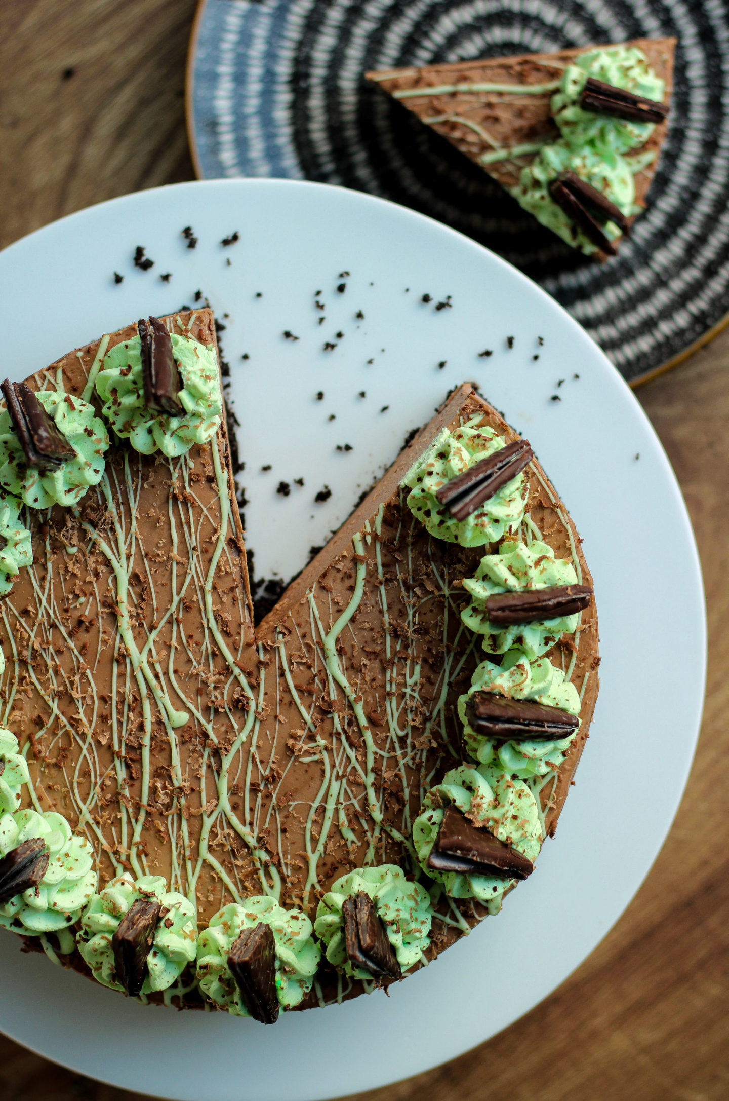 Overhead view of no-bake mint chocolate cheesecake with slice taken from it