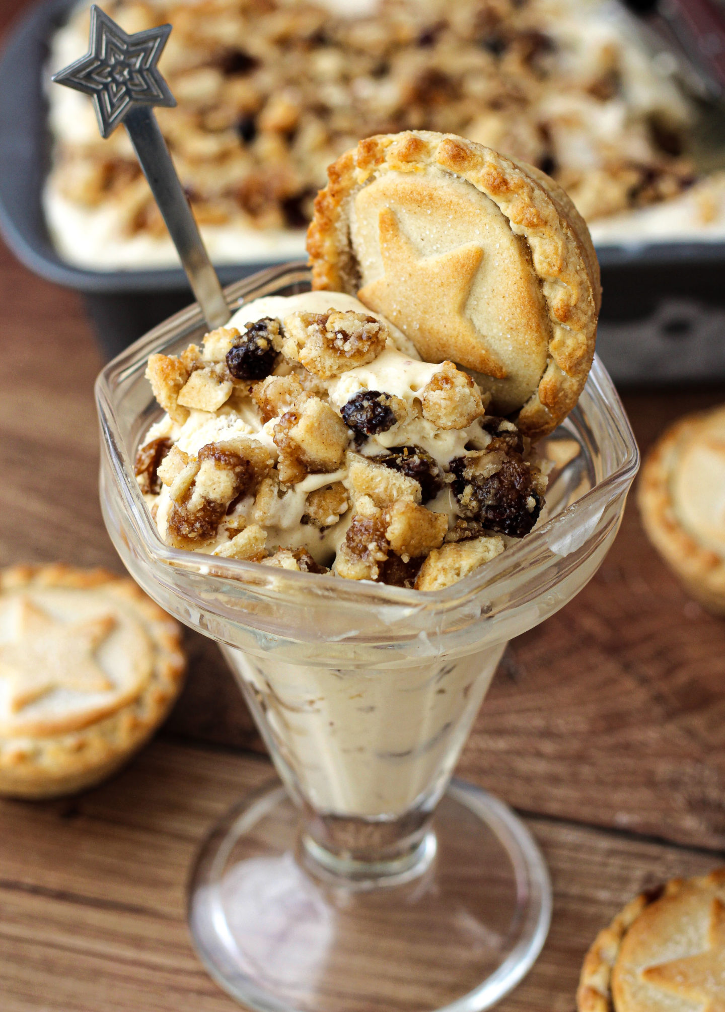 no-churn mince pie ice cream  in a sundae dish with loaf tin of ice cream in background