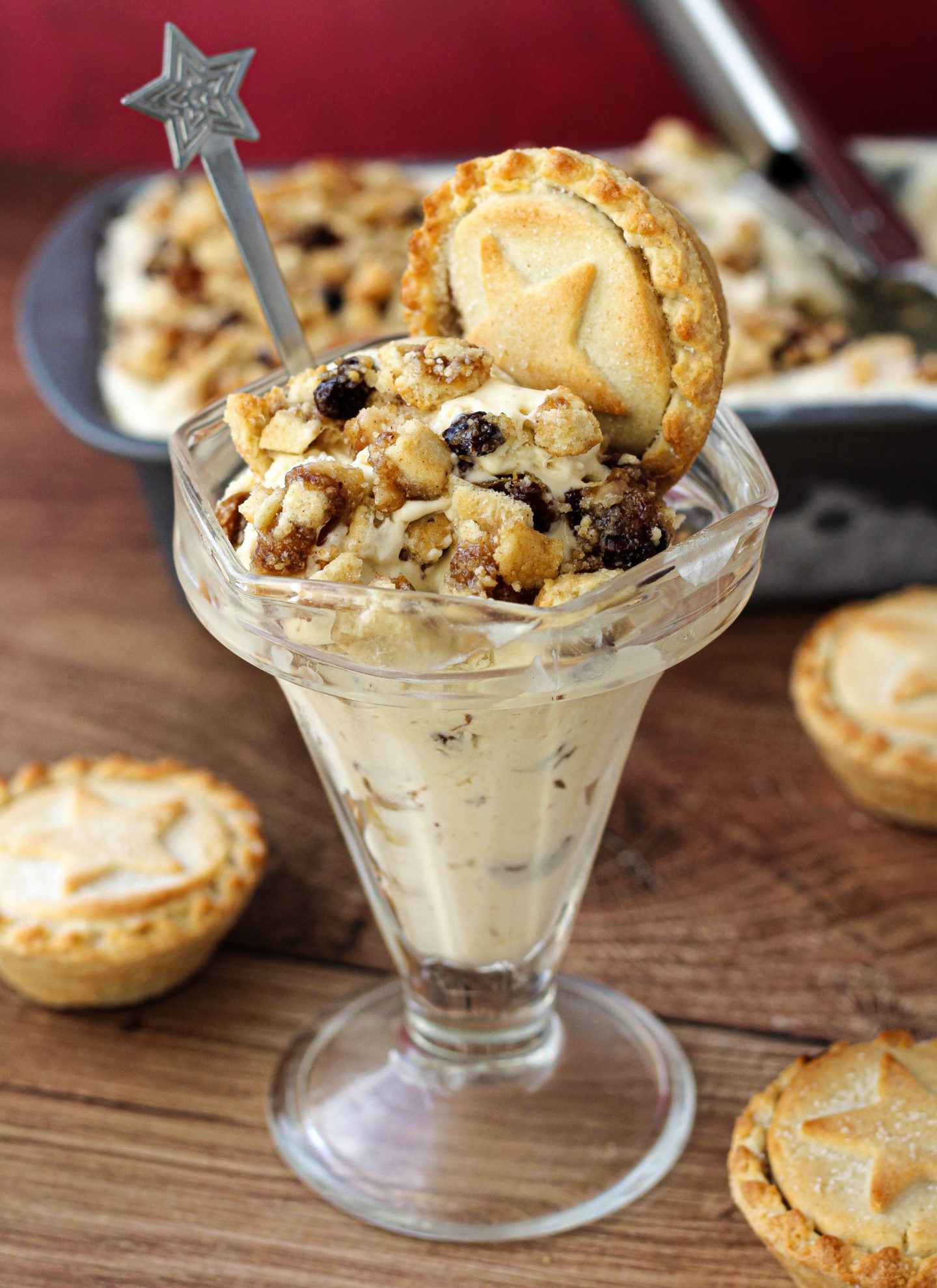 no-churn mince pie ice cream in a sundae dish with mince pie on top and loaf tin of mince pie ice cream in background
