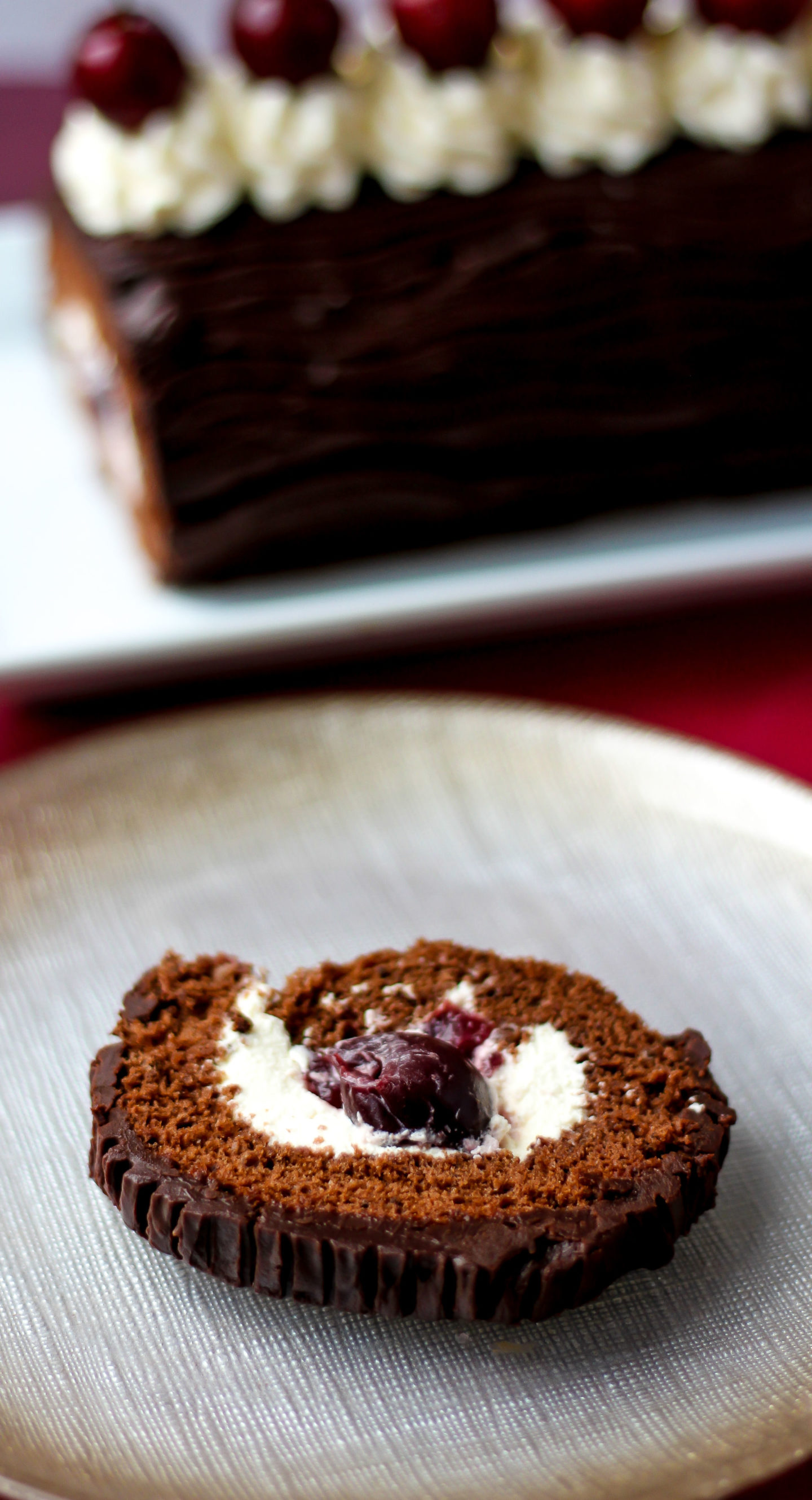close up of slice of black forest swiss roll