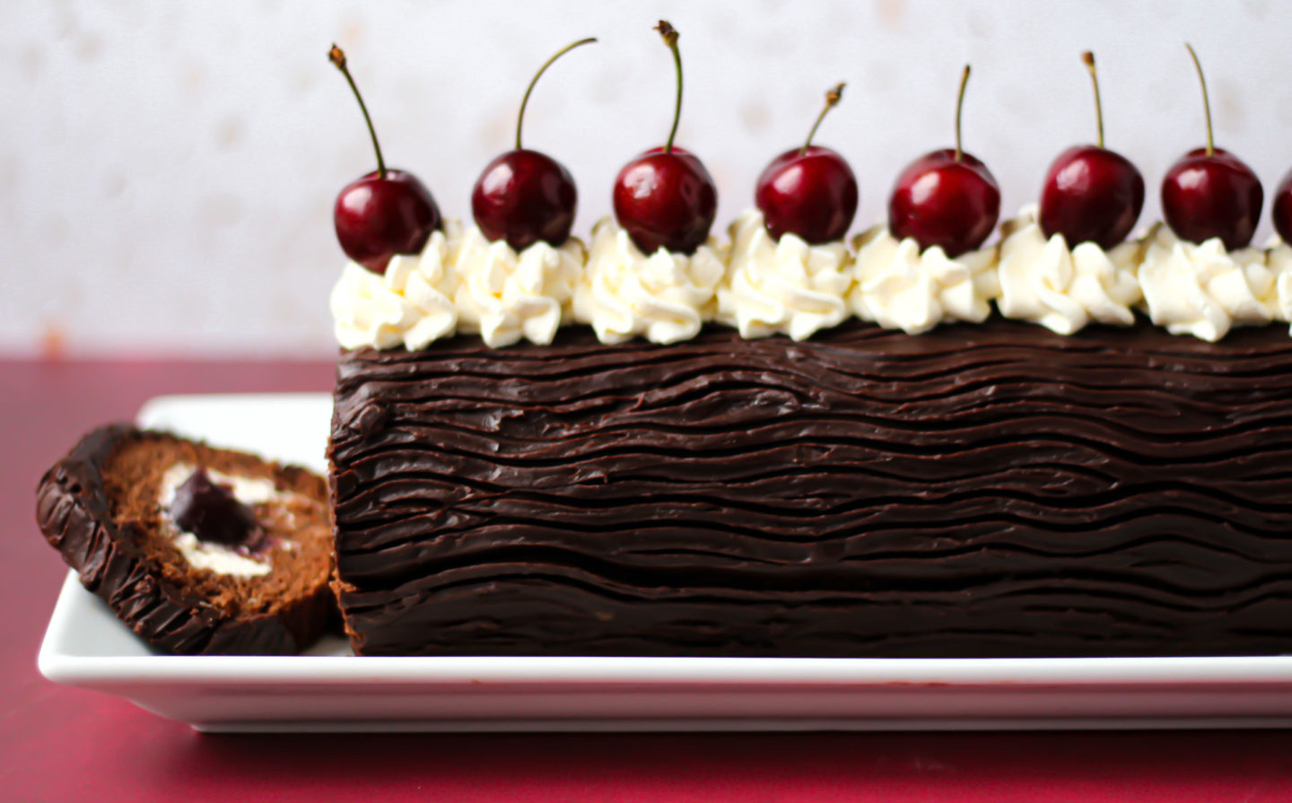 side on view of sliced black forest swiss roll