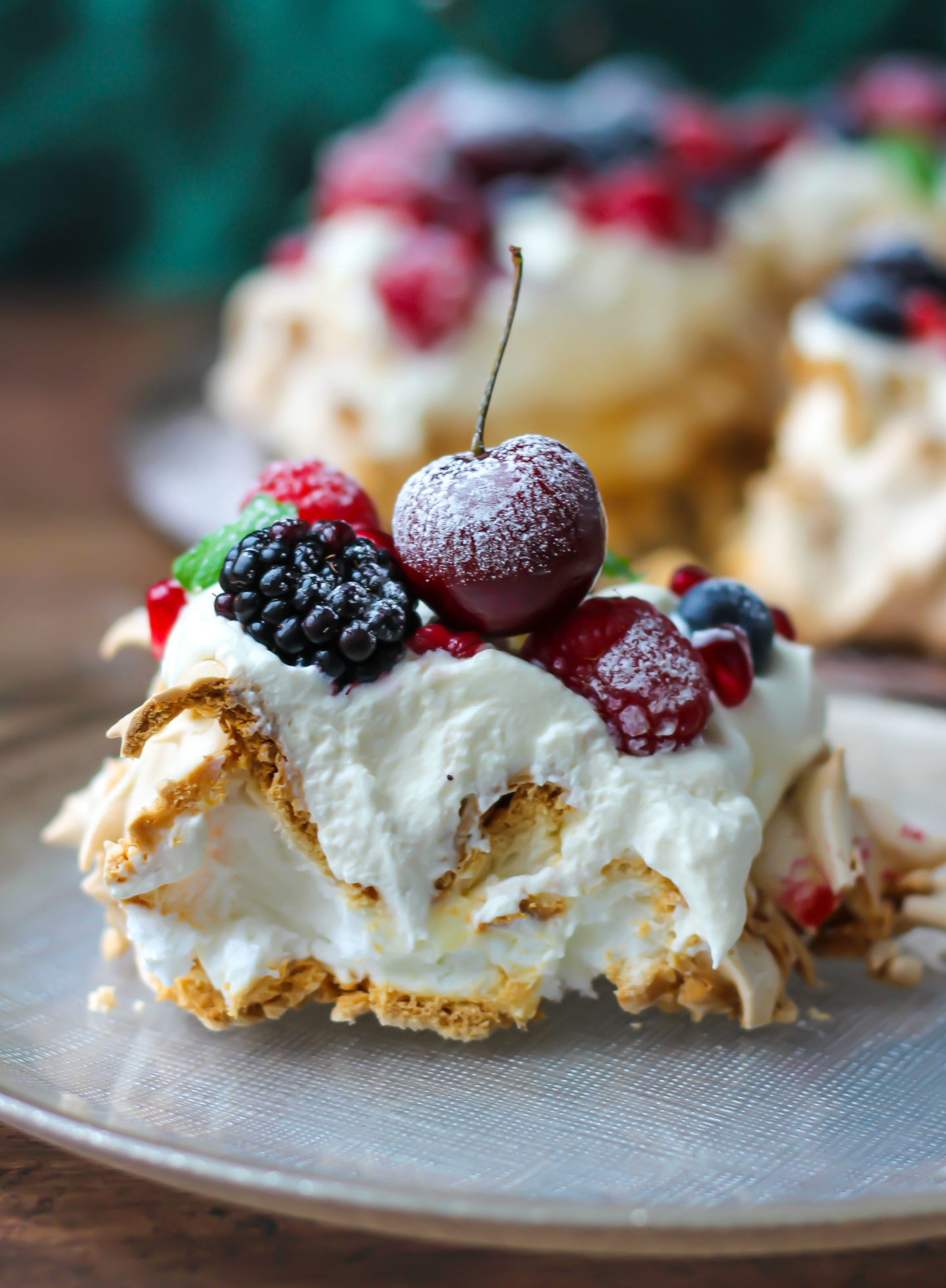 close up side on view of a slice of Christmas berry pavlova wreath