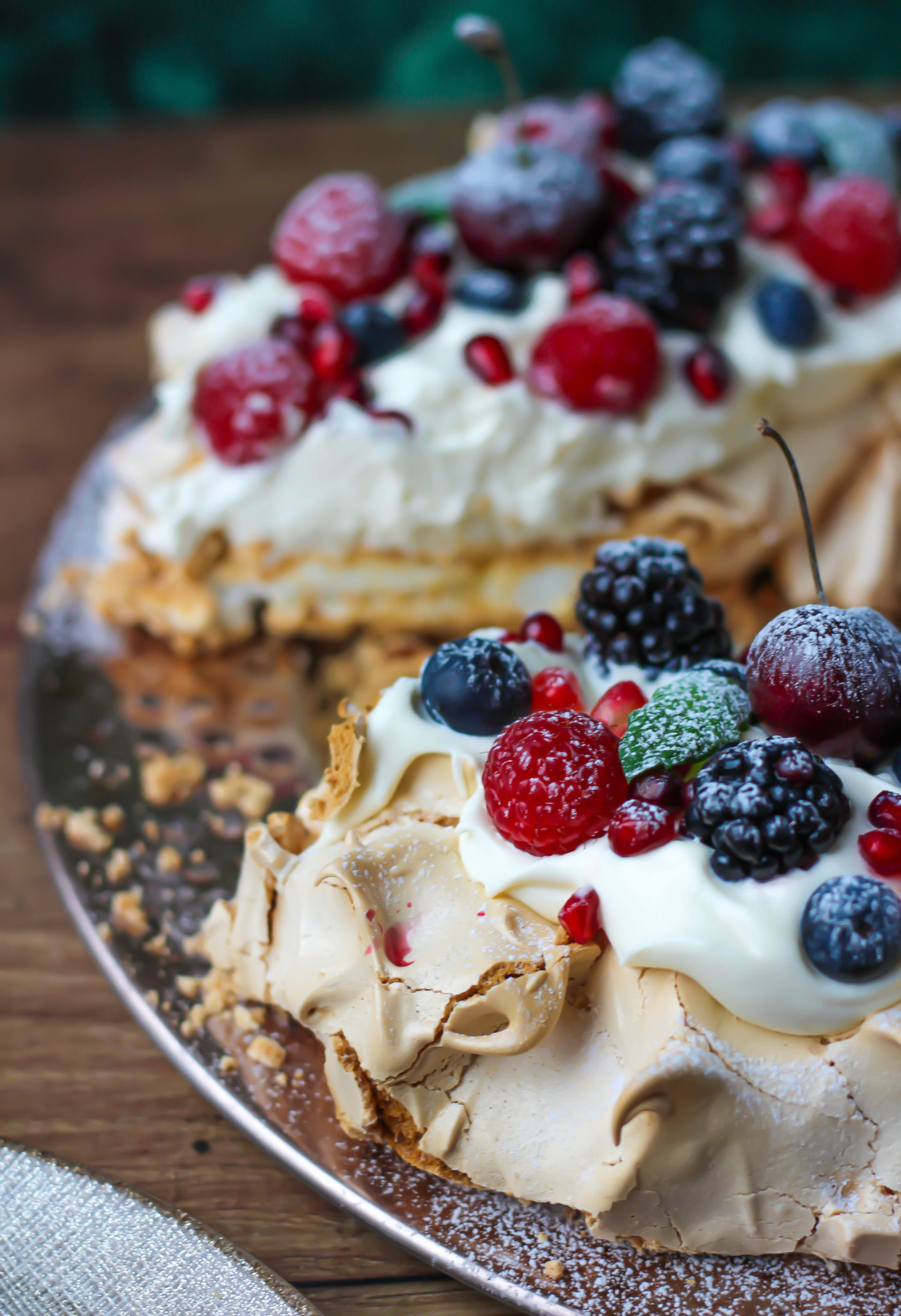 close up of sliced Christmas berry pavlova wreath