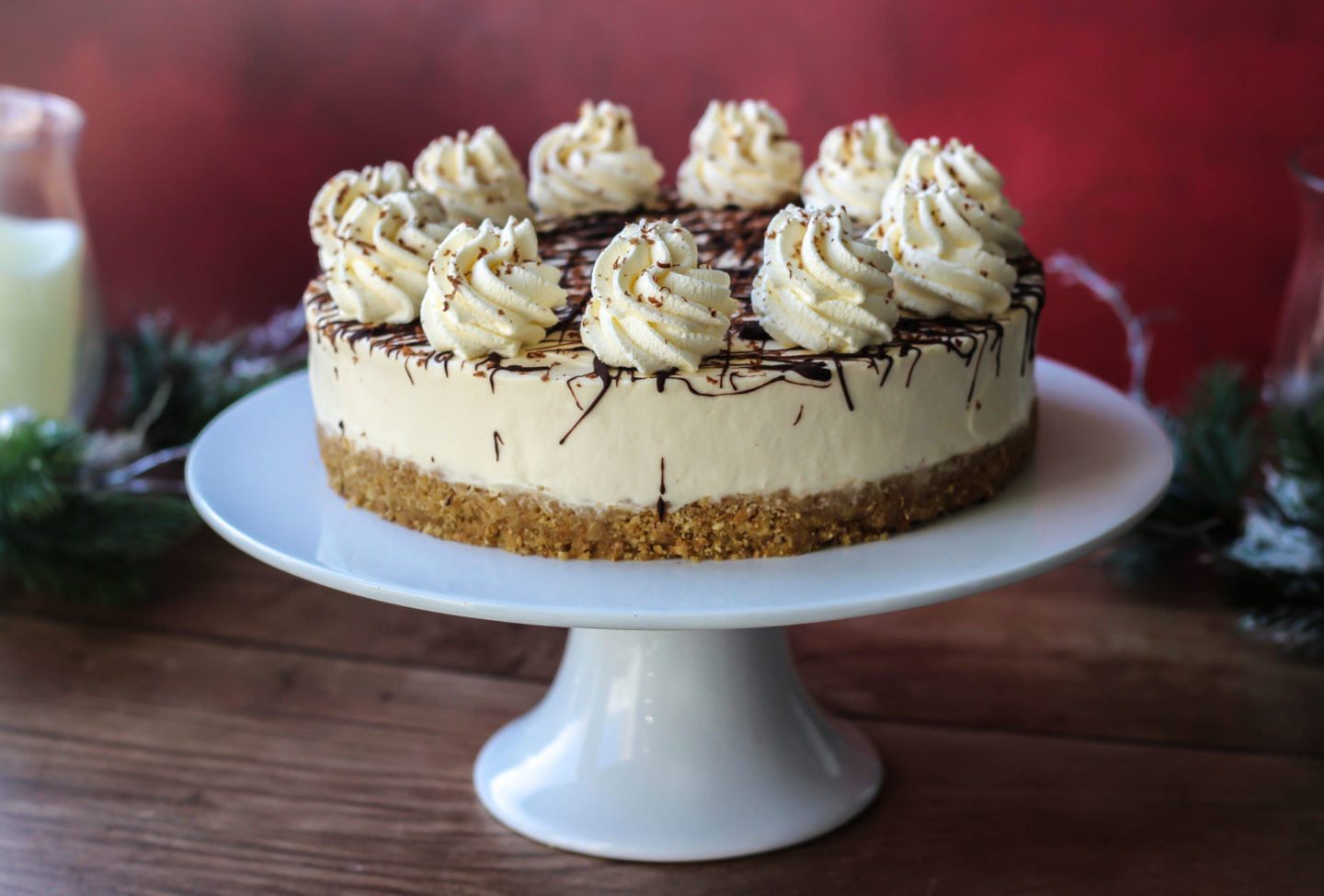 Whole no-bake Baileys cheesecake on a cake stand