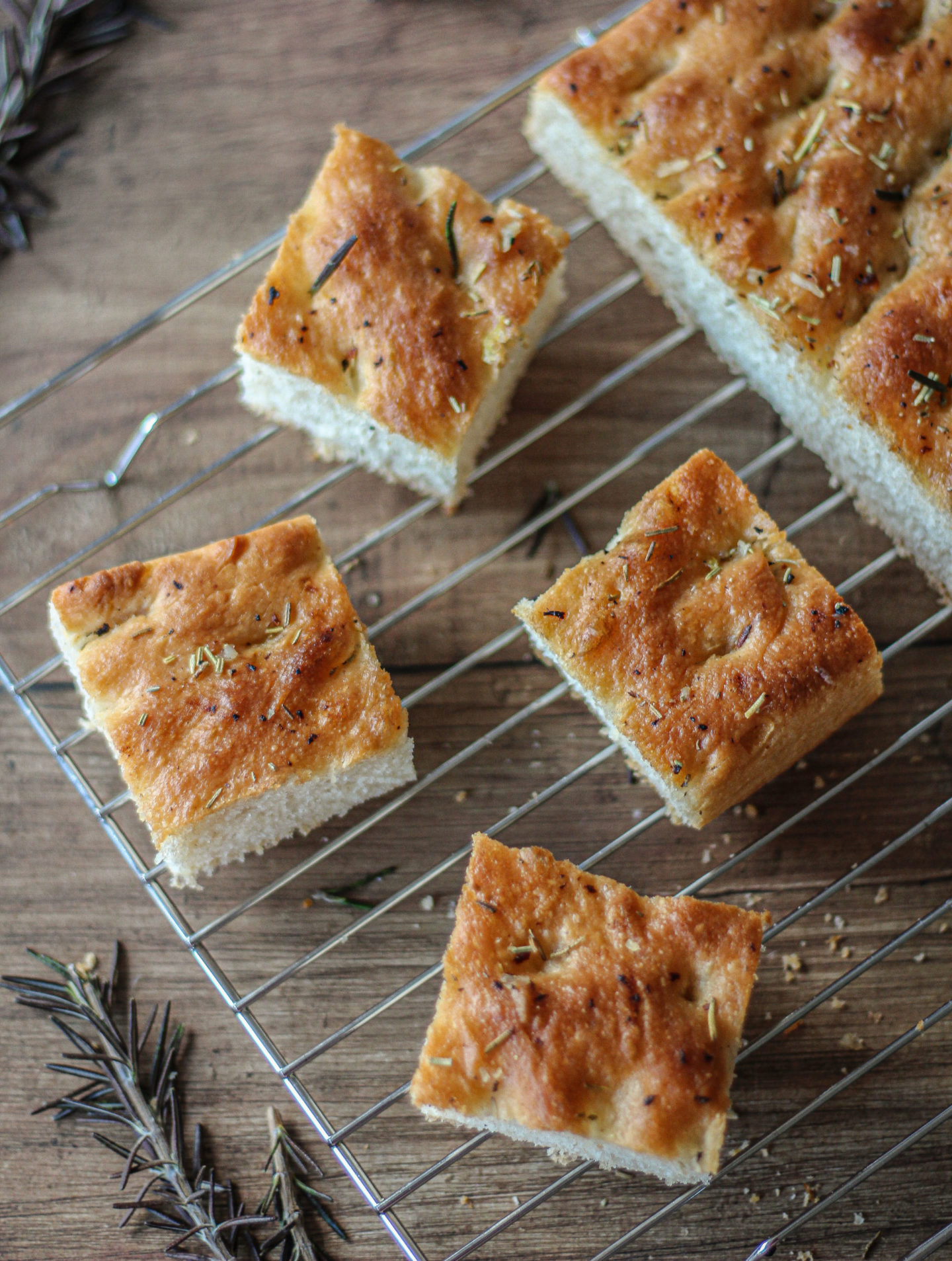 several pieces of garlic and rosemary focaccia on a wire rack