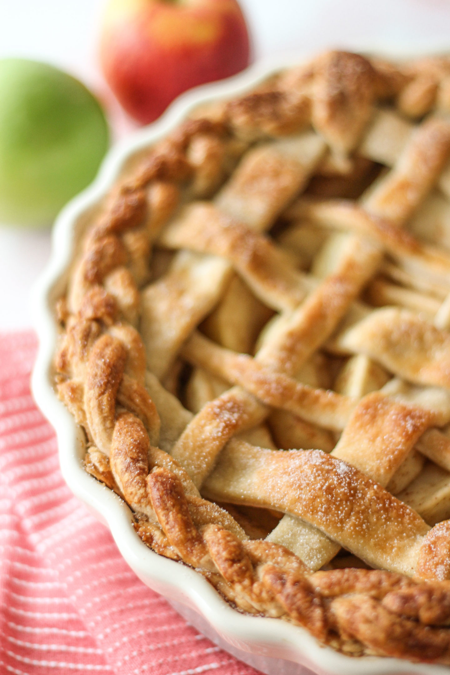 close up of lattice apple pie in pie dish, focussed on outer plaited crust