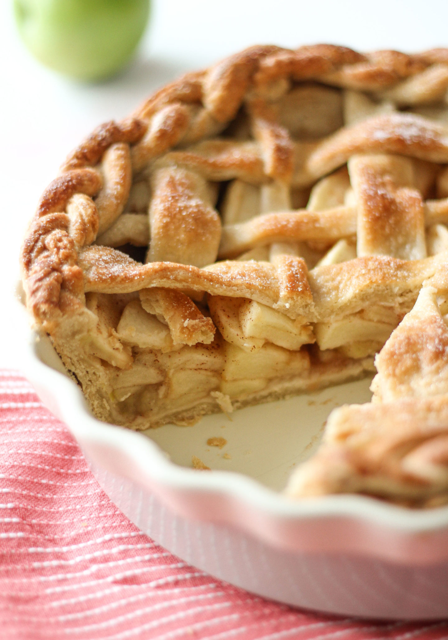 close up of filling inside lattice apple pie in pie dish