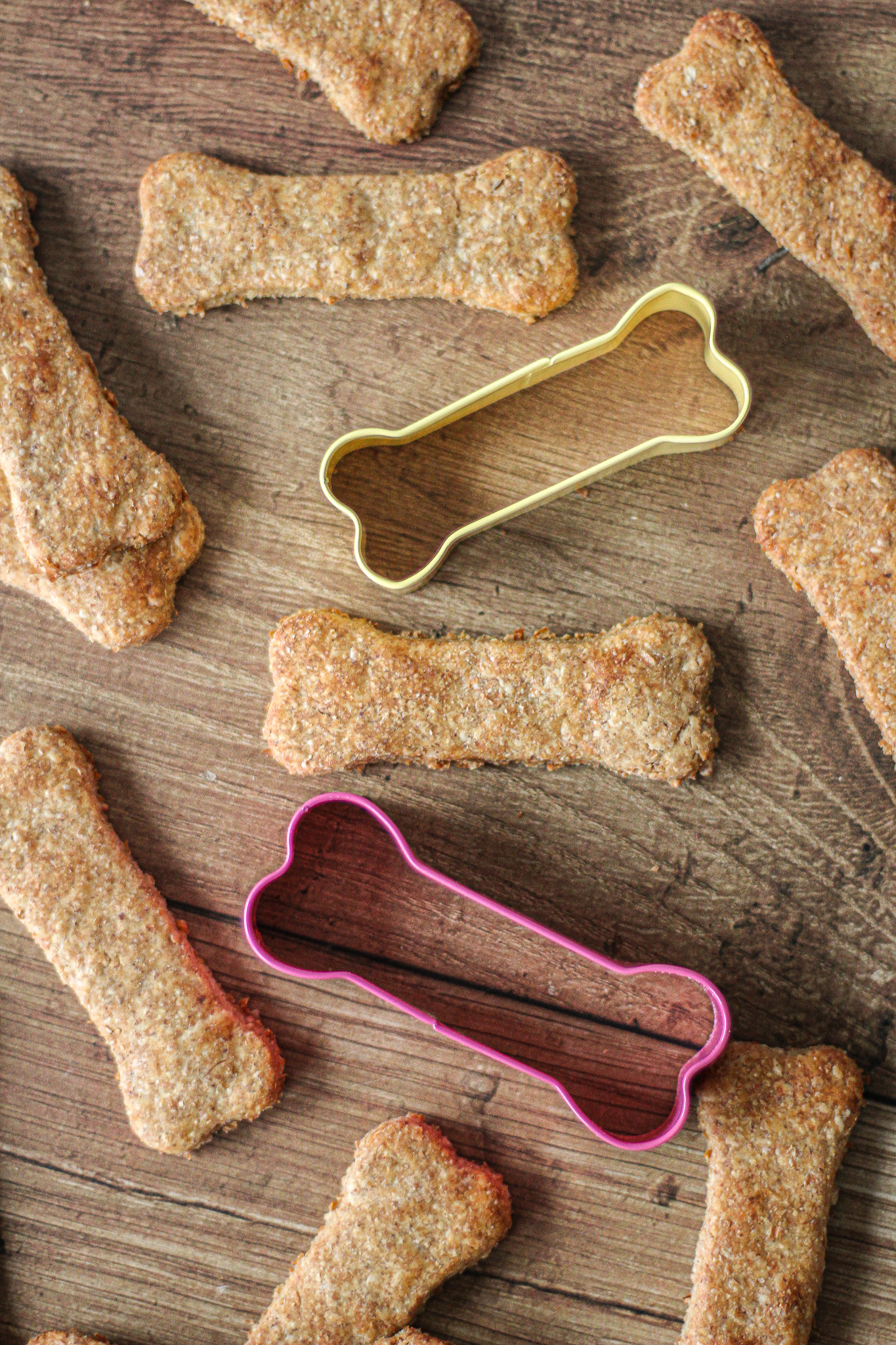 view from above of peanut butter banana dog treats with dog bone shaped cookie cutters between them