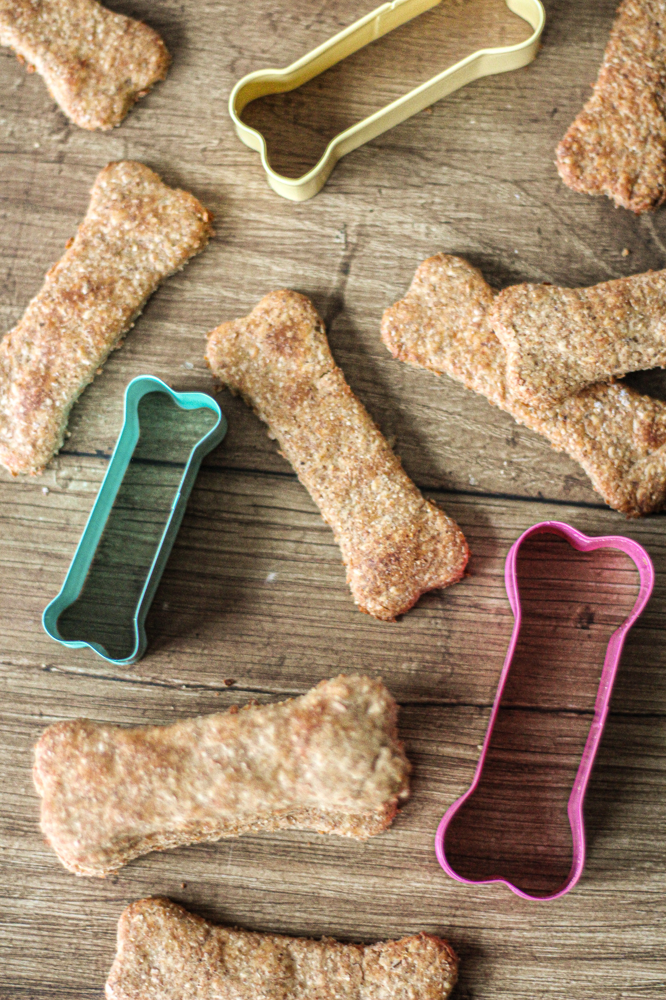 view from above of peanut butter banana dog treats with dog bone shaped cookie cutters between them