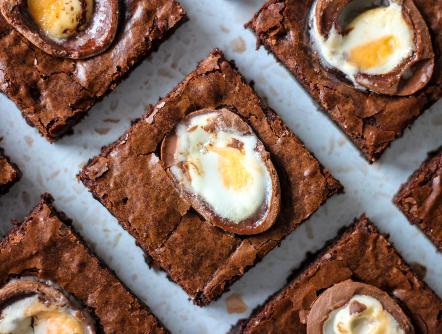 close up view from above of a chewy creme egg brownie surrounded by other brownie slices