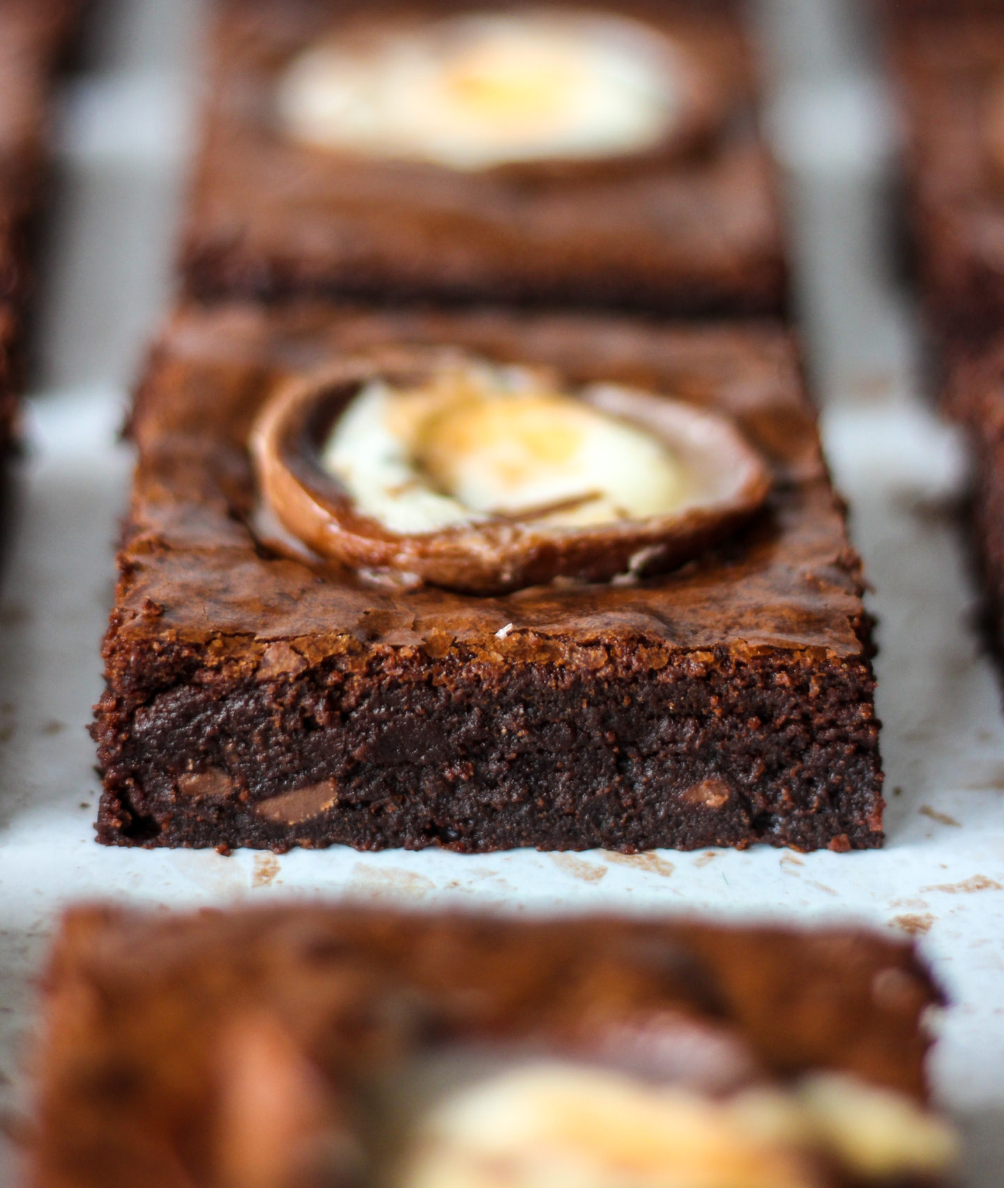 close up side view of a chewy creme egg brownie showing the fudgy centre