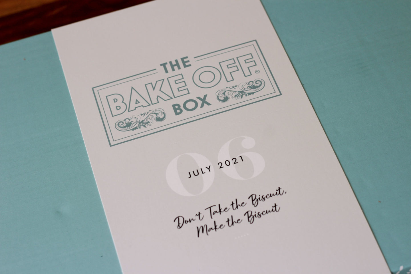 close up of outside of July's Bake Off Box for strawberry and vanilla sandwich biscuits 