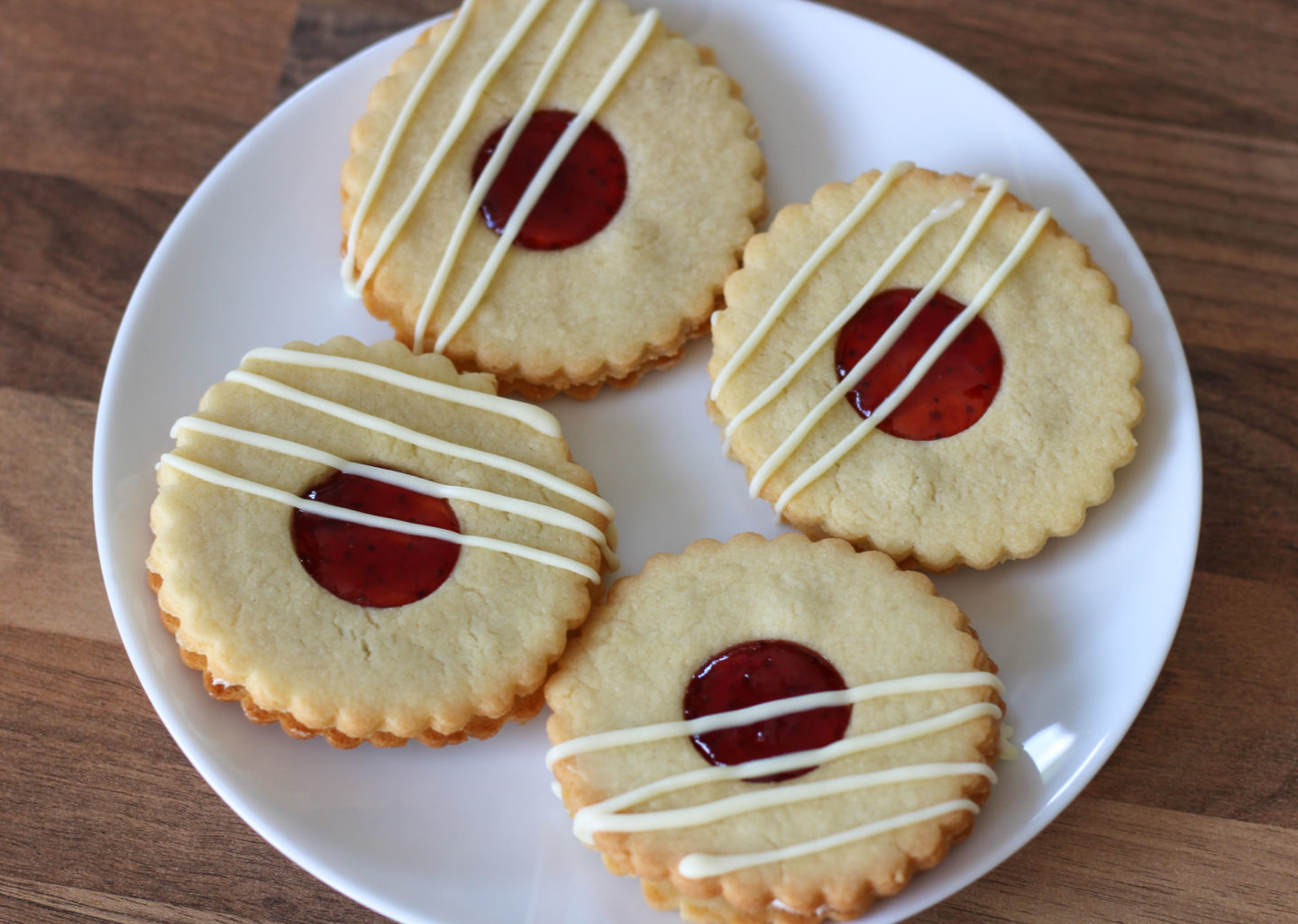 Plate of four strawberry and vanilla sandwich biscuits